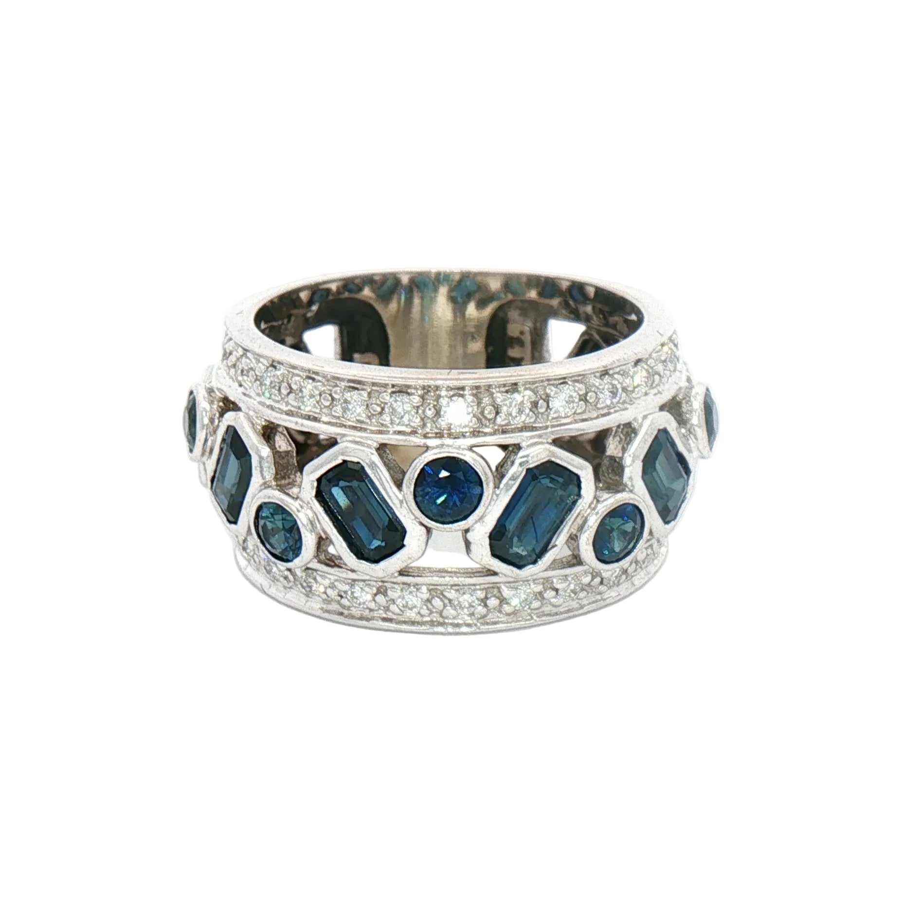 A wide white gold ring featuring alternating dark blue baguette and round gemstones, bordered by rows of small clear stones.
