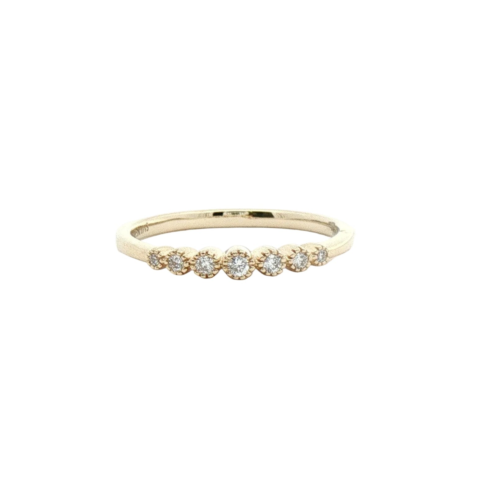 A delicate yellow gold band ring featuring a row of small, round-cut clear gemstones in a floral cluster setting.
