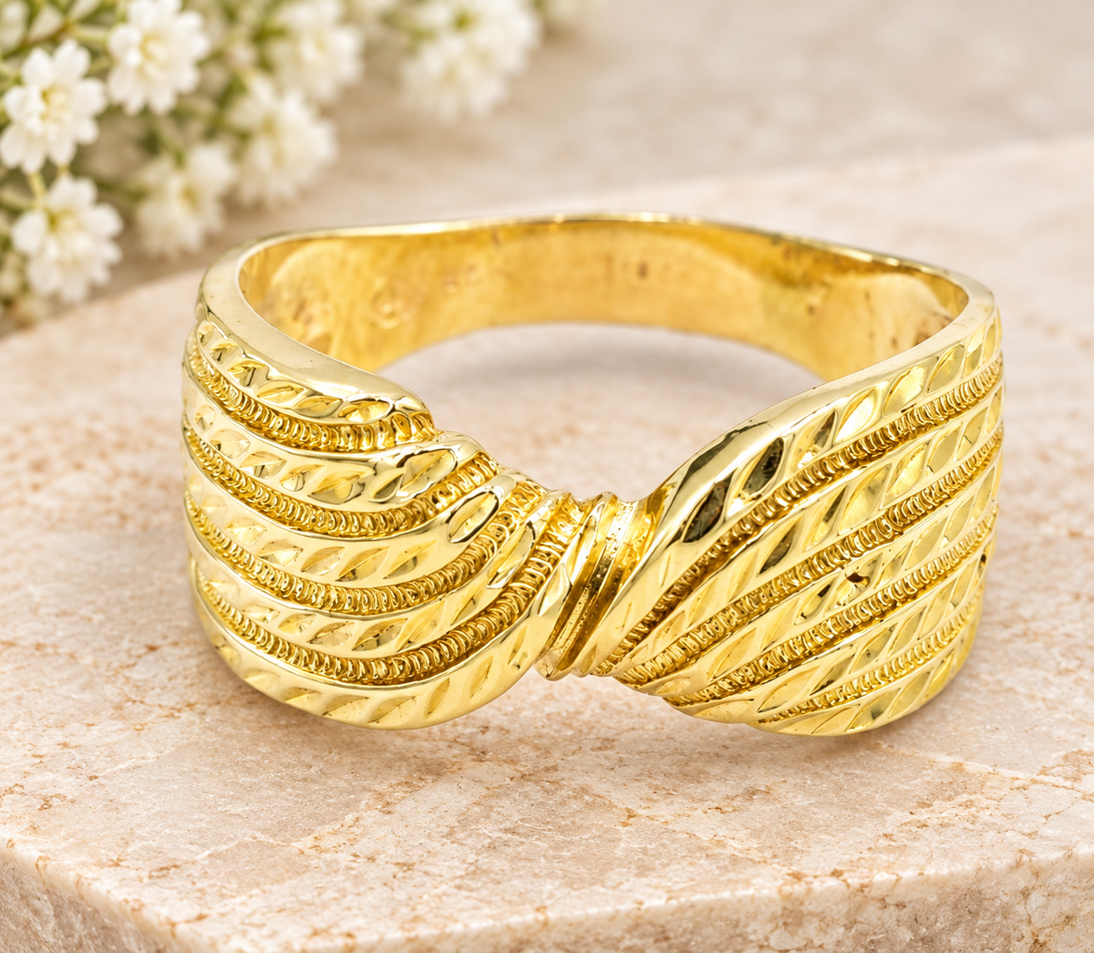 Kent Island Jewelry 14k Yellow Gold Diamond Cut Bow Intertwined Ring with a wide band and a textured bow knot design.