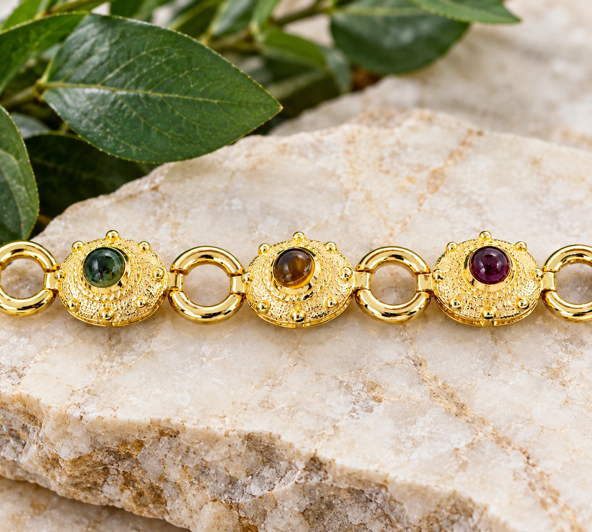 Estate. Yellow Gold Multi Gemstone Decorative Chain Link Bracelet with circular stations of green, brown, and red cabochons.