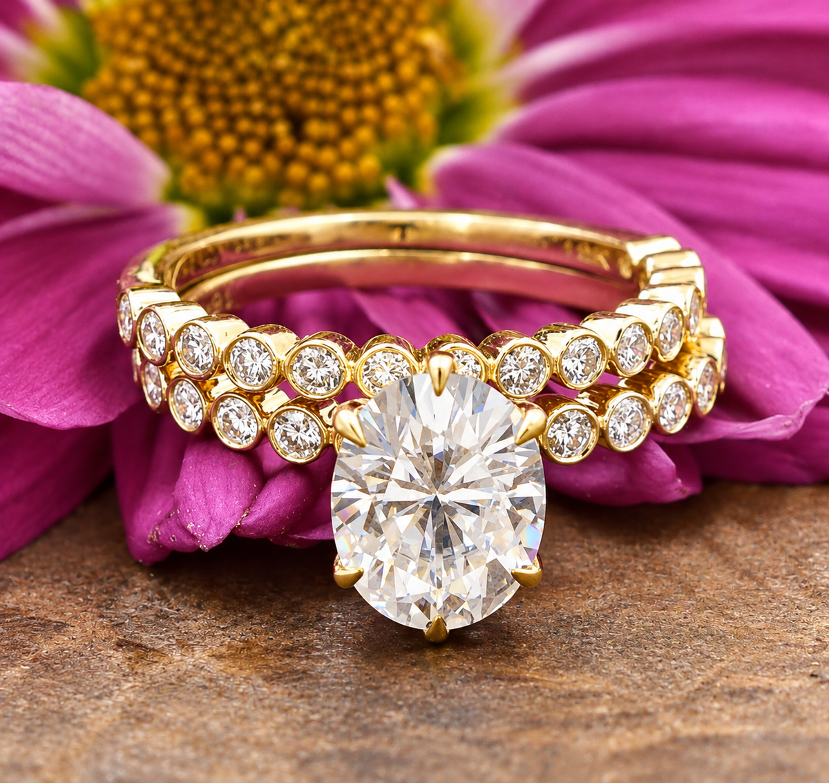 18k Yellow Gold Moissanite Wedding Engagement Set with an oval-cut stone and diamond band resting on a purple flower.