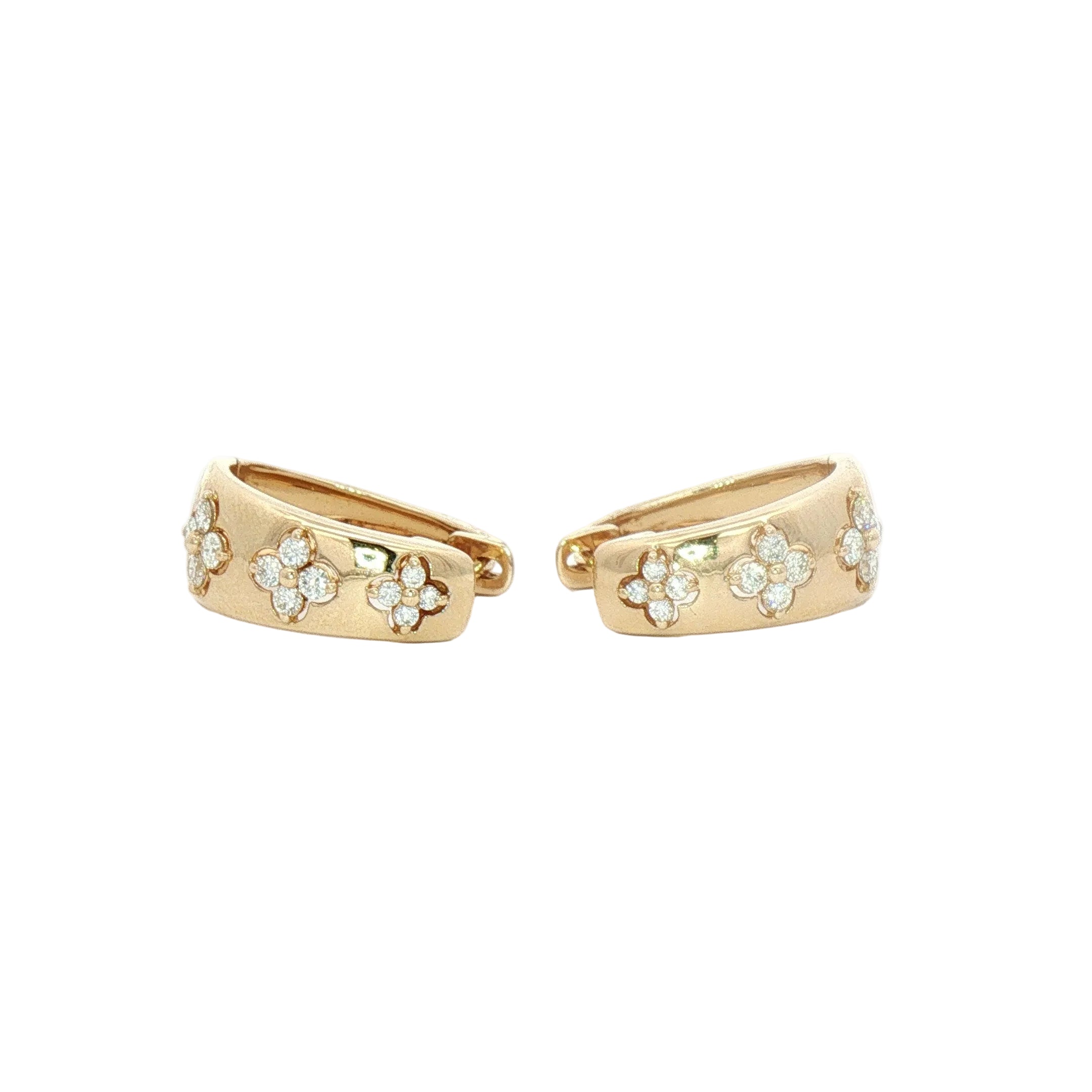 A pair of gold huggie hoop earrings decorated with small flower clusters of clear stones, shown on a plain white background.