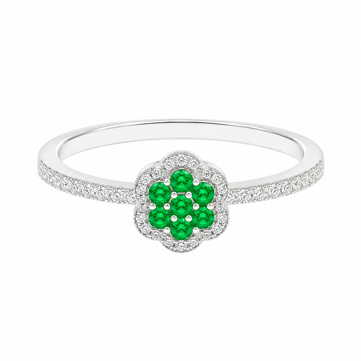 A white gold flower-shaped ring featuring a central cluster of green emerald-cut gemstones surrounded by small clear stones, with the band paved with clear stones, shown on a white background.