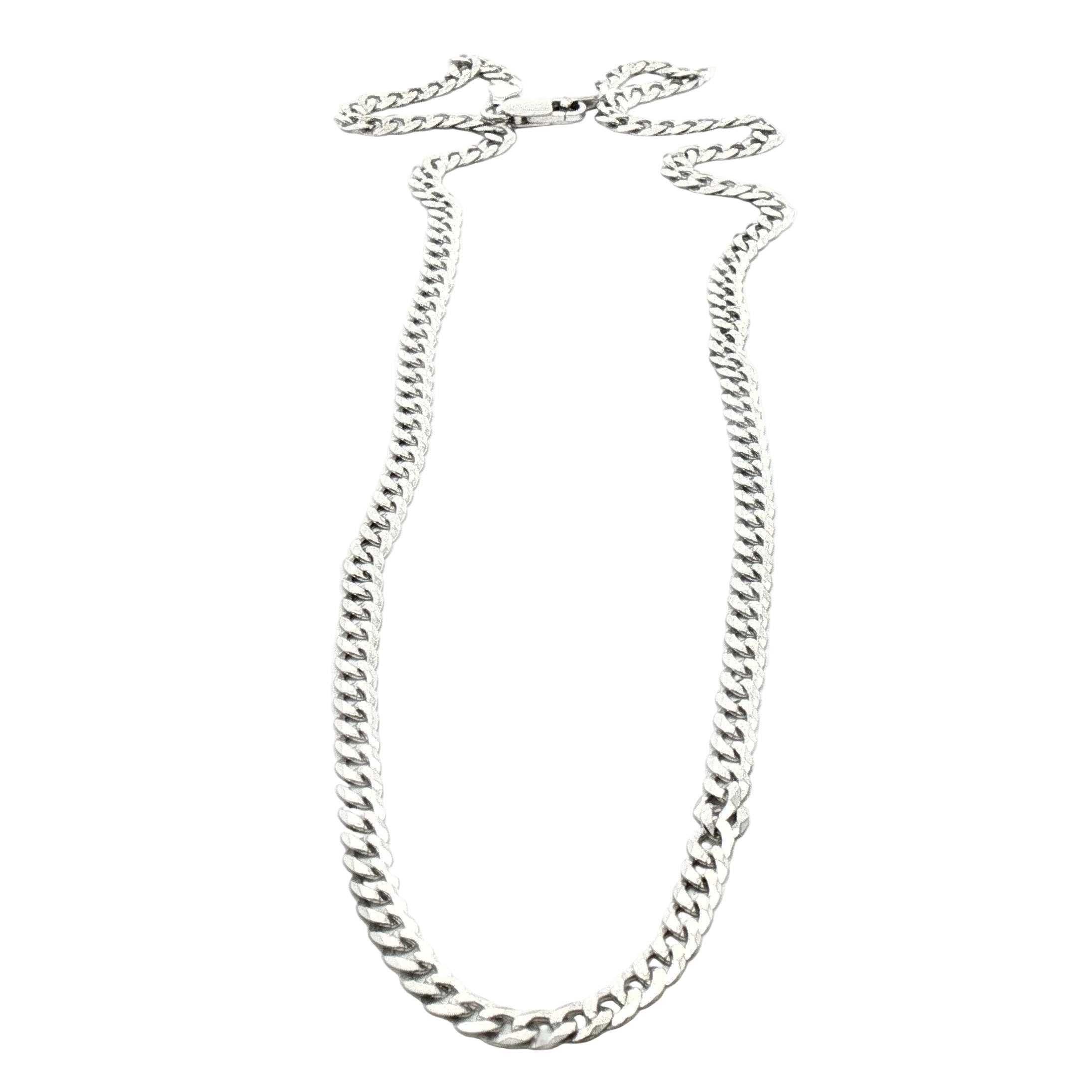 A silver-toned curb chain necklace arranged in a loop on a plain white background.