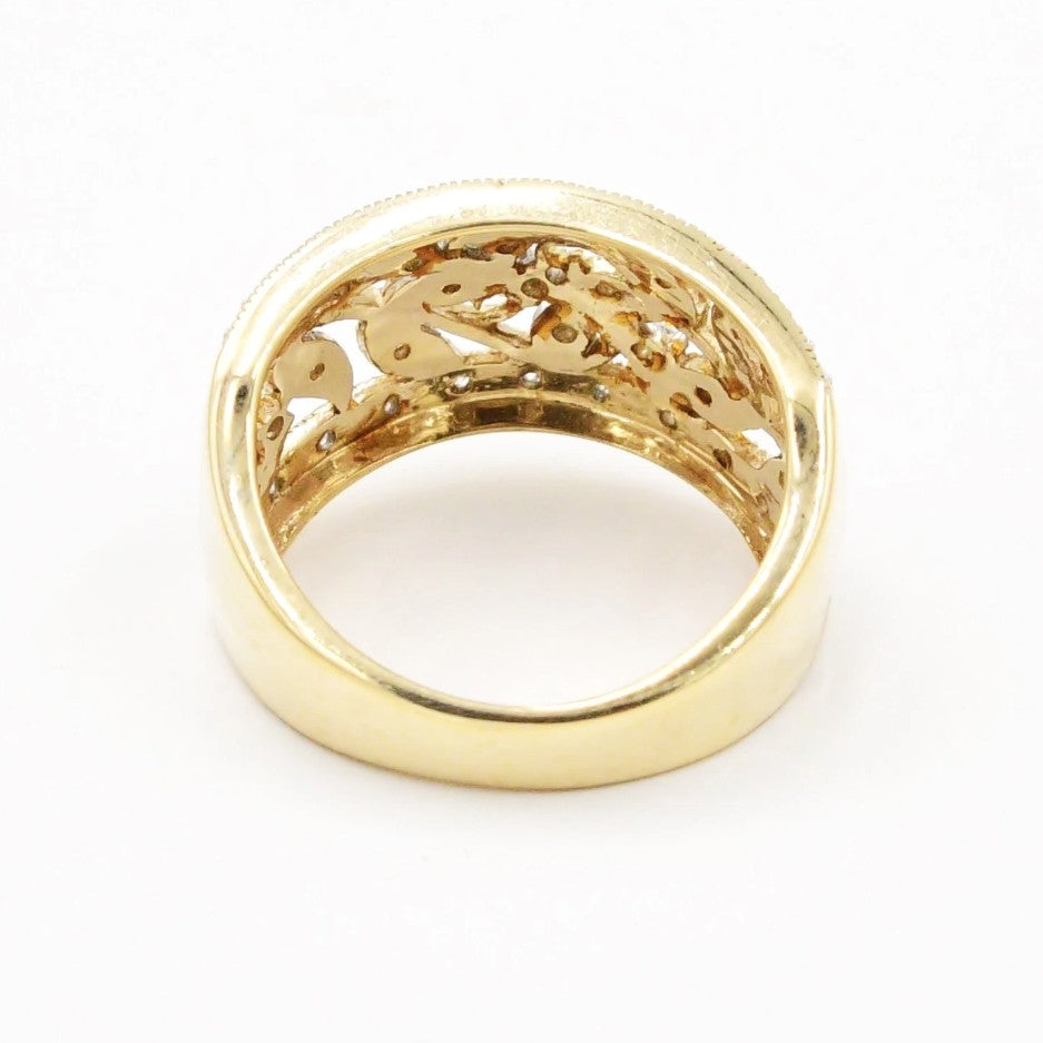 A Kent Island Jewelry Estate 10k two-tone diamond (.26 ctw) open work ring, side view on white background.