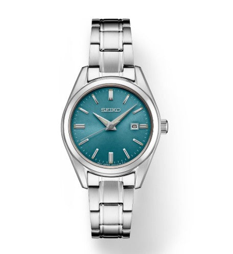 The Seiko Essentials SS Quartz watch features a blue dial, date at 3 o’clock, and a water resistant stainless steel design.
