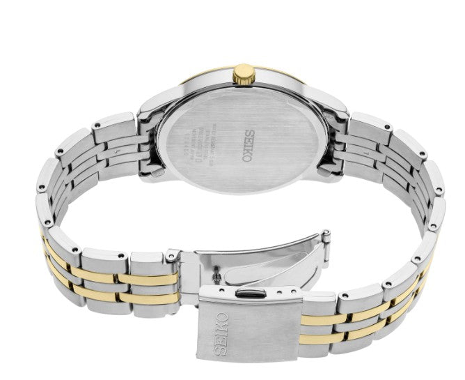 Seiko Essentials SS TT Quartz watch with white dial, gold accents, open clasp, and engraved case back.