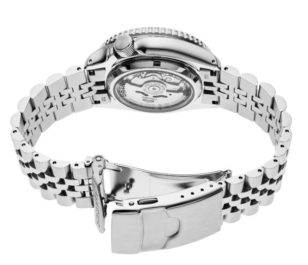 Seiko 5 Sports SS Automatic GMT with yellow dial and metal bracelet, featuring an exposed automatic movement and clasp.