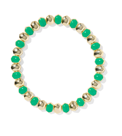 Kendra Scott Daphne Enamel Stretch Bracelet in gold and green displayed in a circle on white—an elegant accessory.