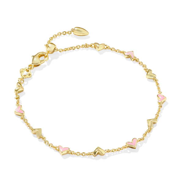 The Kendra Scott HAVEN bracelet features gold chain, pink enamel hearts, and dainty heart charms for a romantic look.