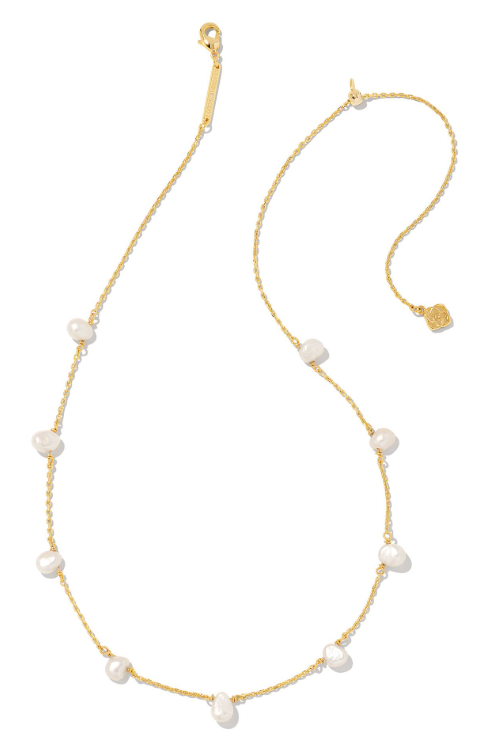 Kendra Scott LEIGHTON Pearl Strand Necklace in Gold with white pearls and a gold charm, shown on a white background.