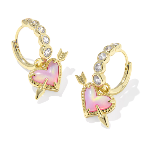 Kendra Scott Ari Heart Arrow Huggie Earrings in gold with pink opalescent resin and rhinestone details.