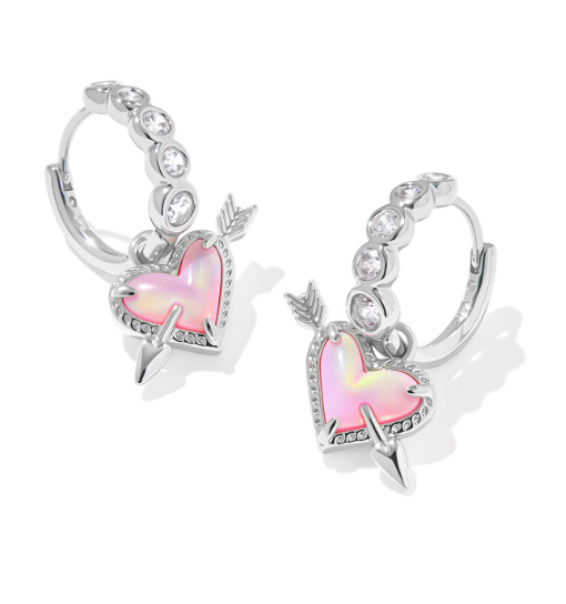 Kendra Scott Ari Heart Arrow huggie earrings in silver with pink opalescent resin charms and CZ accents.