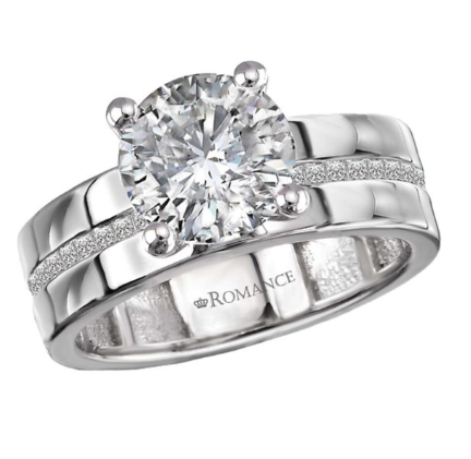 The Romance Diamond Semi-Mount Engagement Ring features a large round diamond on a 14kt white gold band.