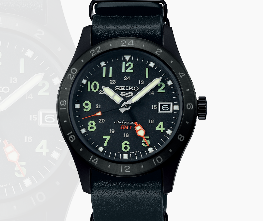 Seiko 5 Sports Watch—automatic GMT, black bezel, luminous hands, date window, and black leather strap.