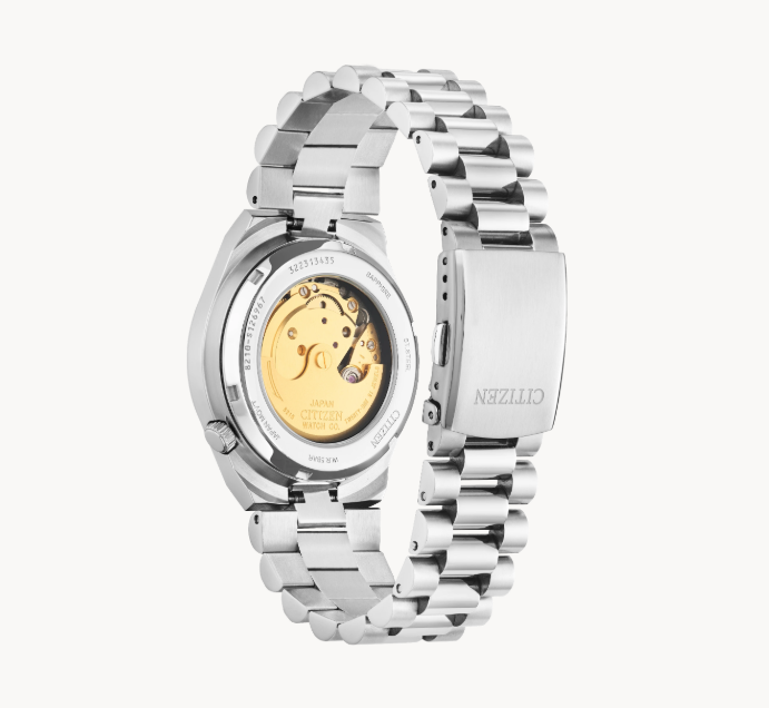 Citizens TSUYOSA Watch with open clasp, showing gold-toned movement through the case back.