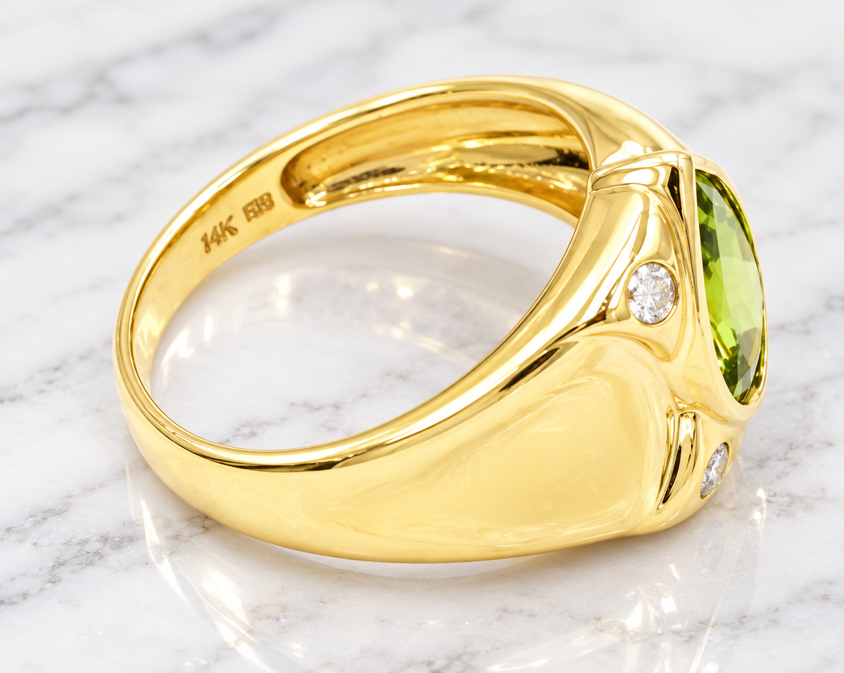Estate 14k Yellow Gold Diamond & Pear Cut Peridot Gemstone Ring featuring a pear-cut peridot and two diamond accents.
