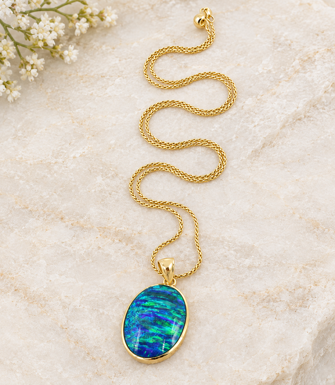 Kent Island Jewelry 14k Yellow Gold Opal Gemstone Seahorse Nautical Wheat Chain Necklace with an oval blue opal pendant.