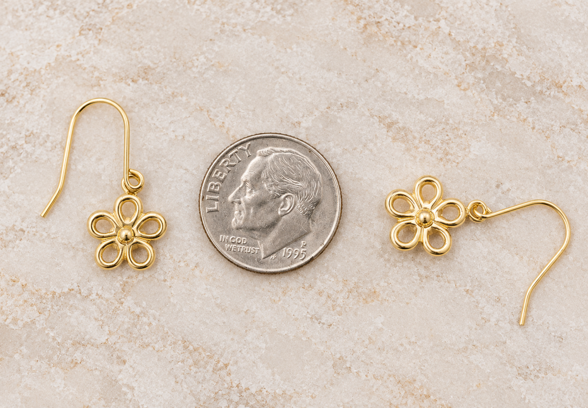 Estate 14k Yellow Gold Open Work Flower Dangle earrings shown next to a US dime for scale.