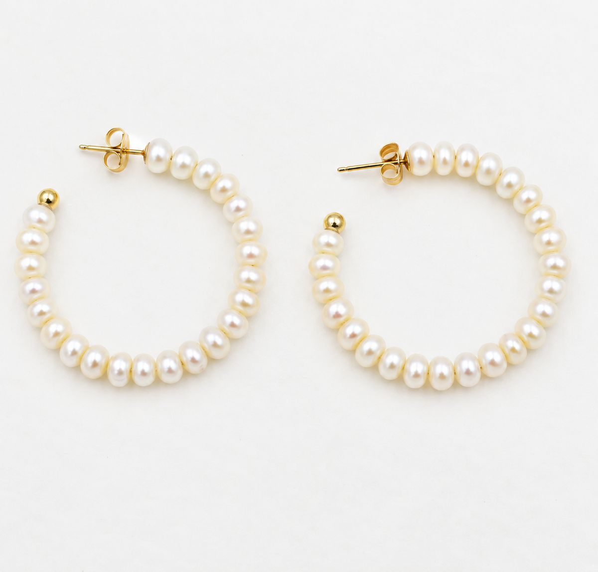 Estate 14k Yellow Gold Pearl Hoops, a pair of 14K yellow gold hoop earrings lined with small white pearls.