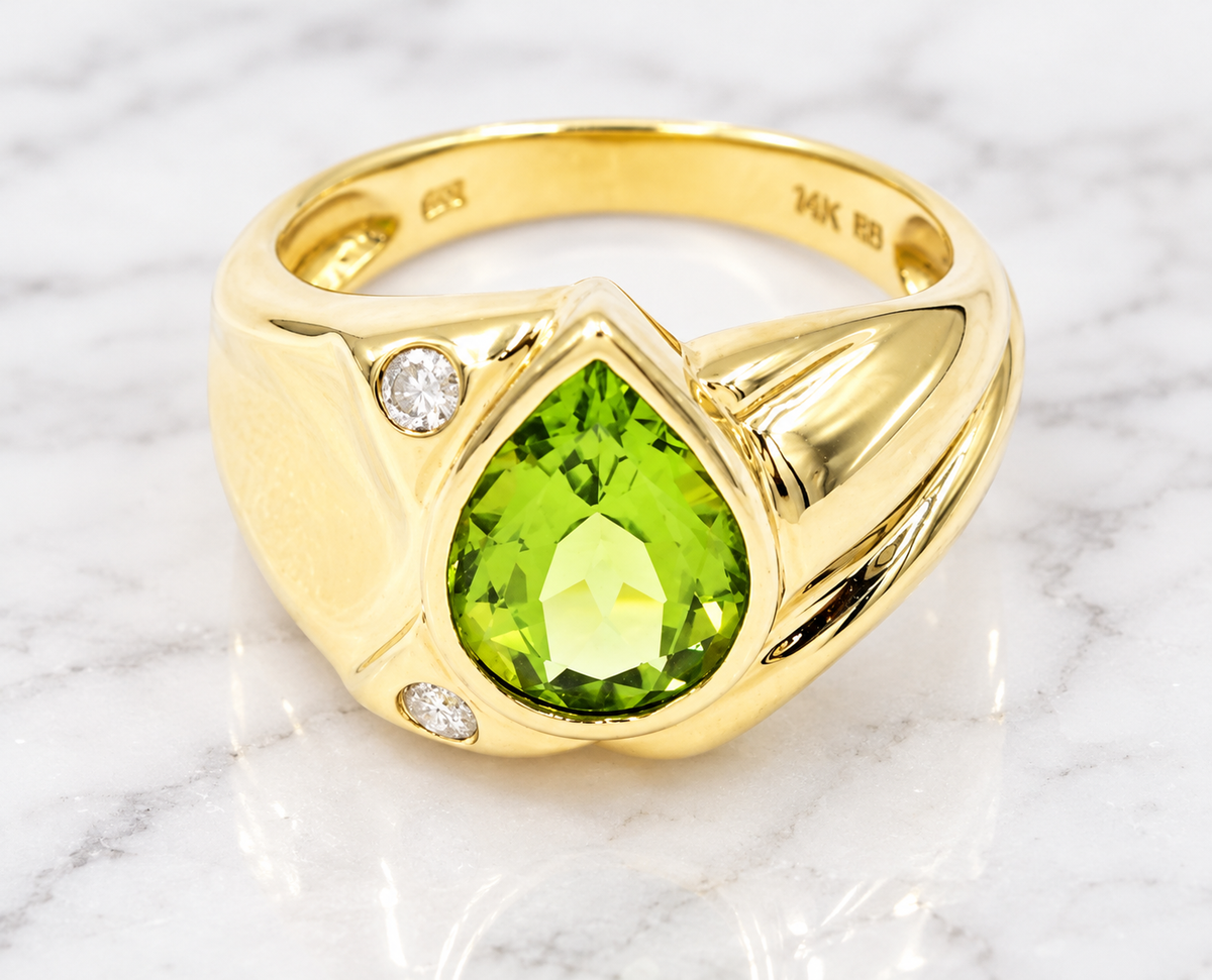Kent Island Jewelry Estate 14k Yellow Gold Diamond & Pear Cut Peridot Gemstone ring with a central pear-cut peridot.