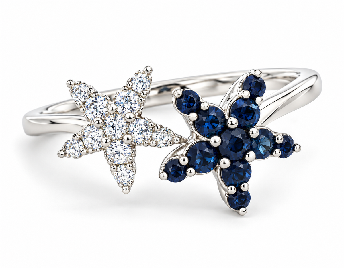 A white gold ring featuring two starfish-shaped floral clusters, one set with clear round diamonds and the other with deep blue round sapphires, shown on a white background.