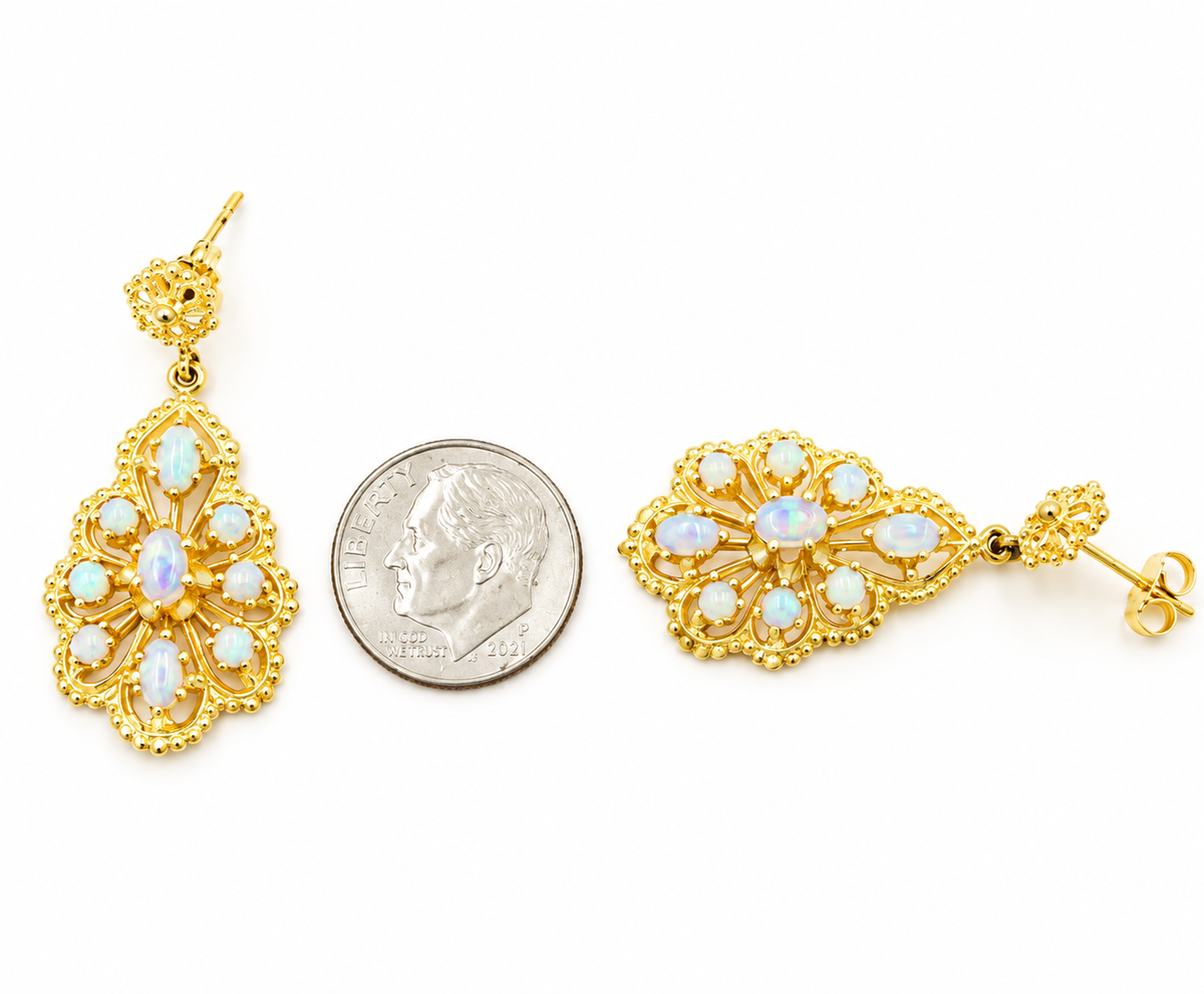 Kent Island Jewelry 14k Yellow Gold Fire Opal Gemstone Open Work Dangle Earrings shown next to a US dime for scale.