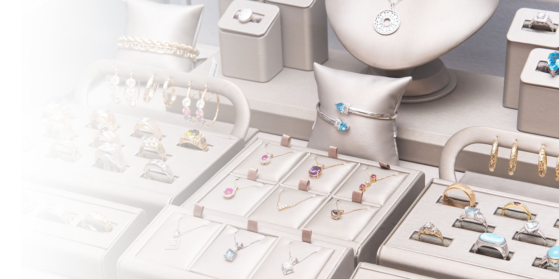 Jewelry display with rings, earrings, and necklaces on a white surface
