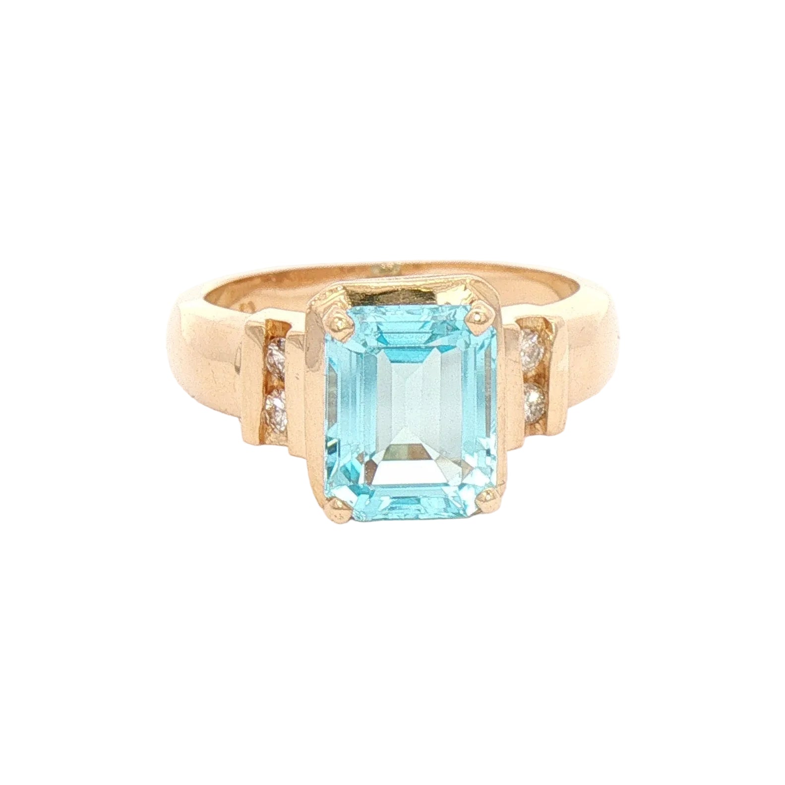 A yellow gold ring featuring a large emerald-cut topaz in the center, accented by two small round-cut diamonds on either side of the band.