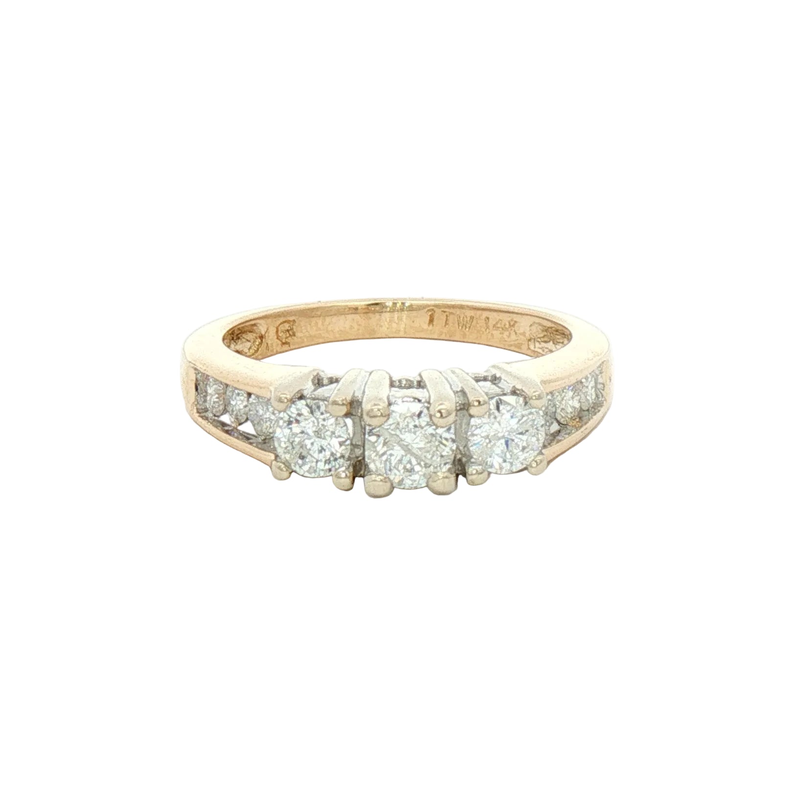 A yellow gold diamond ring with a three-stone center and channel-set diamonds on either side.