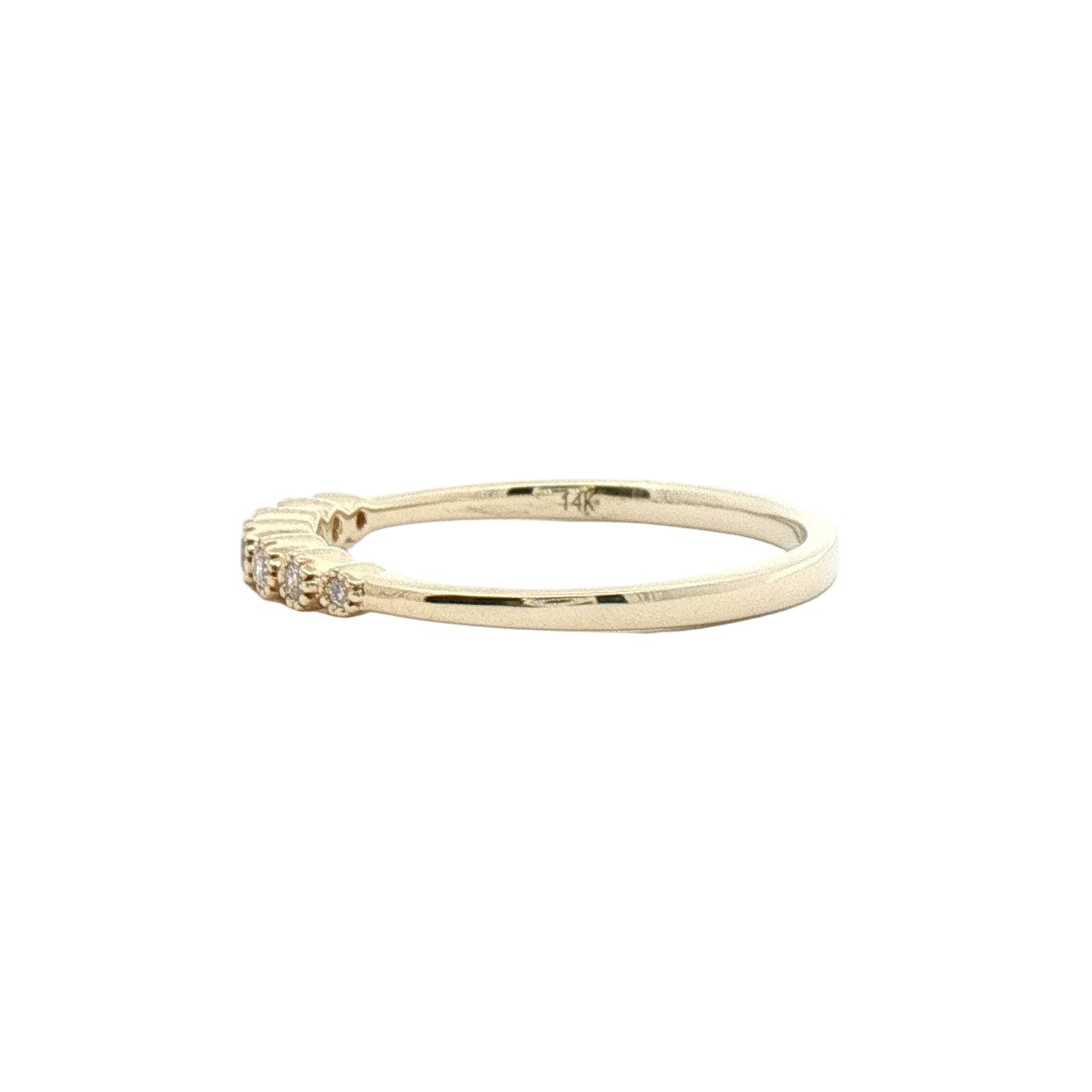A delicate yellow gold ring with a small cluster of clear gemstones on one end.