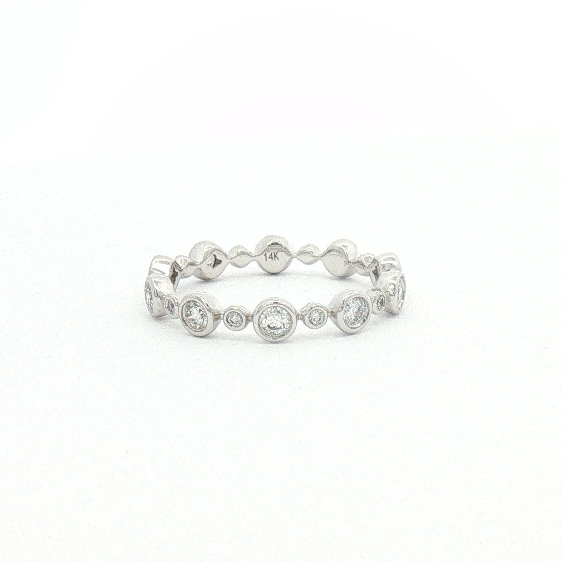 White gold bezel-set diamond band.