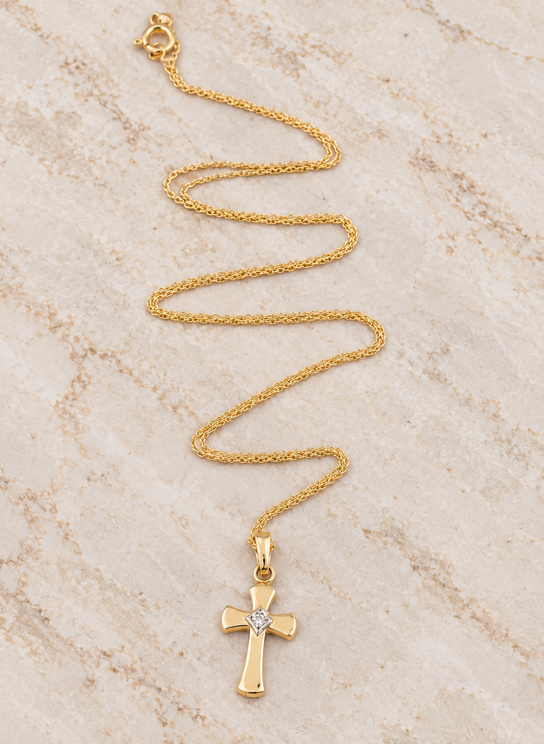 Estate 14k Yellow Gold Diamond Cross Necklace featuring a central diamond on a fine gold chain.