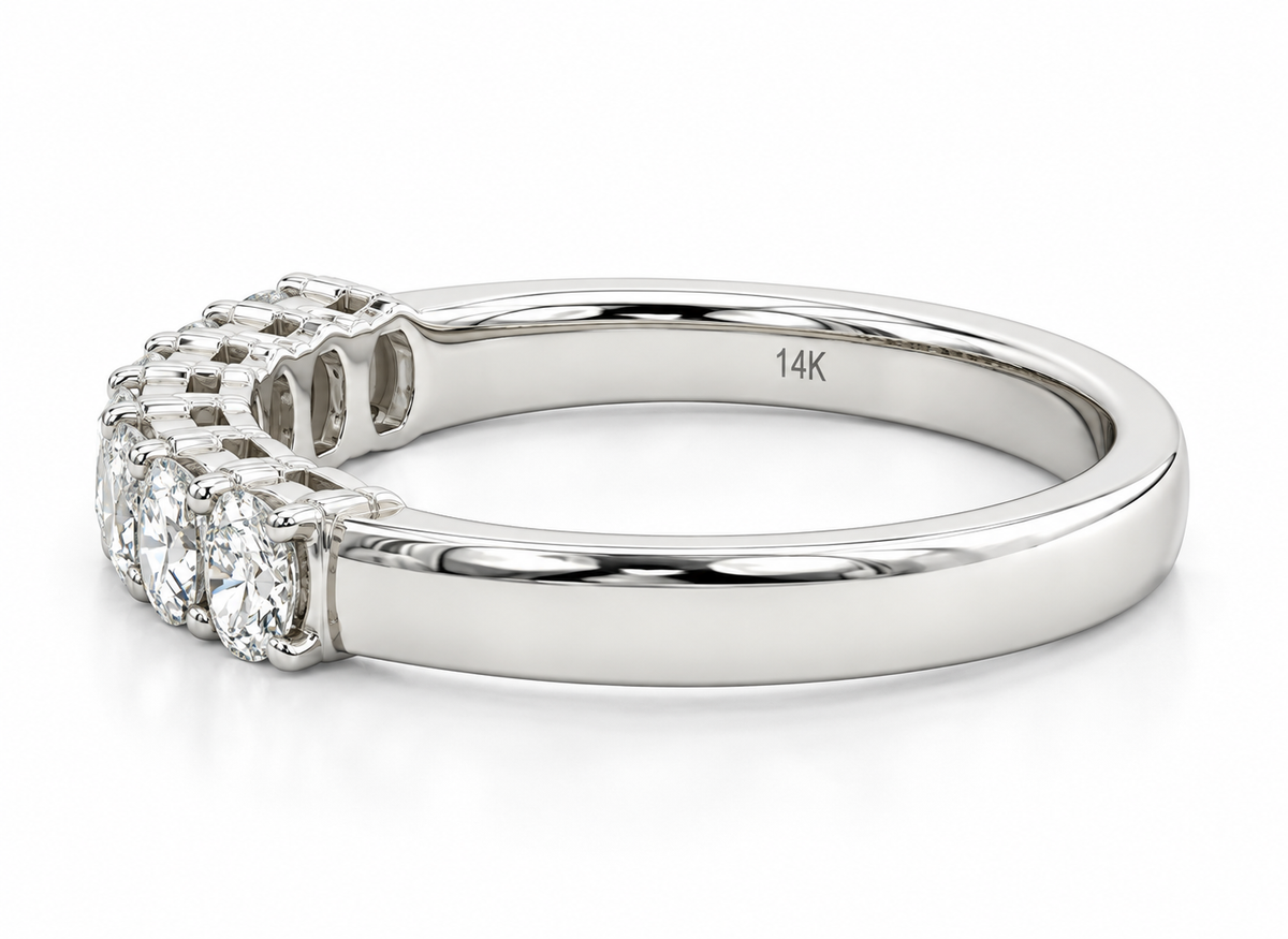 A white gold diamond ring with a curved top featuring a cluster of round-cut diamonds.