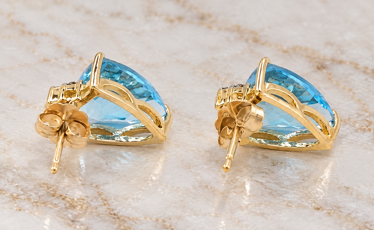 Estate 10k Yellow Gold Diamond & Topaz Gemstone Earrings featuring pear-cut blue topaz studs with butterfly backs.