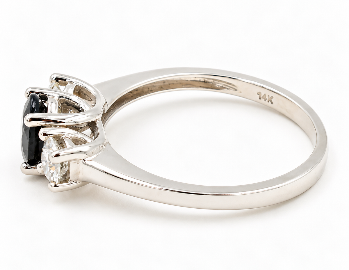 Estate 14k White Gold Diamond & Sapphire Gemstone Three Stone Ring with a dark gemstone flanked by two clear diamonds.