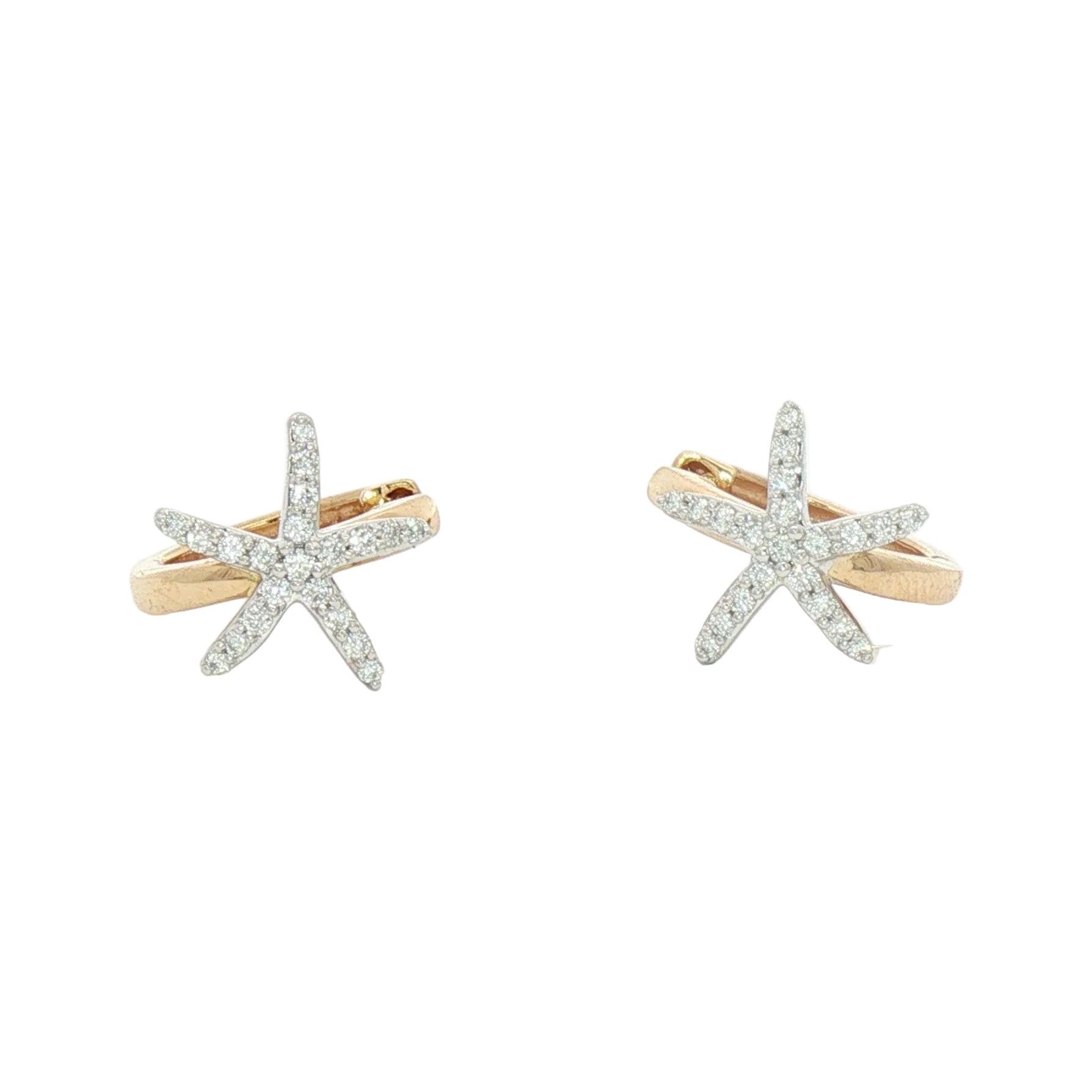 A pair of starfish-shaped stud earrings in yellow gold and white gold, set with small clear pavé gemstones on a plain white background.