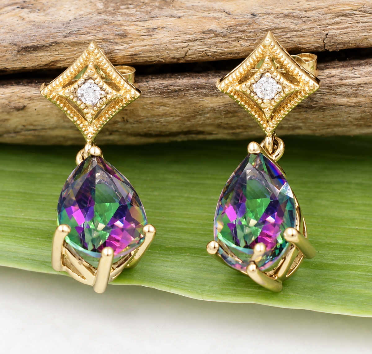 Kent Island Jewelry 10k yellow gold drop earrings with diamond-set square studs and pear-shaped iridescent mystic topaz.