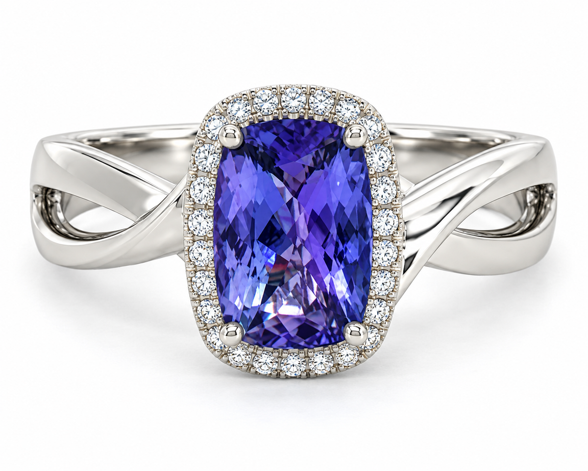 A white gold ring featuring a cushion-cut tanzanite center stone surrounded by a halo of small clear stones, set on a split twisted band.