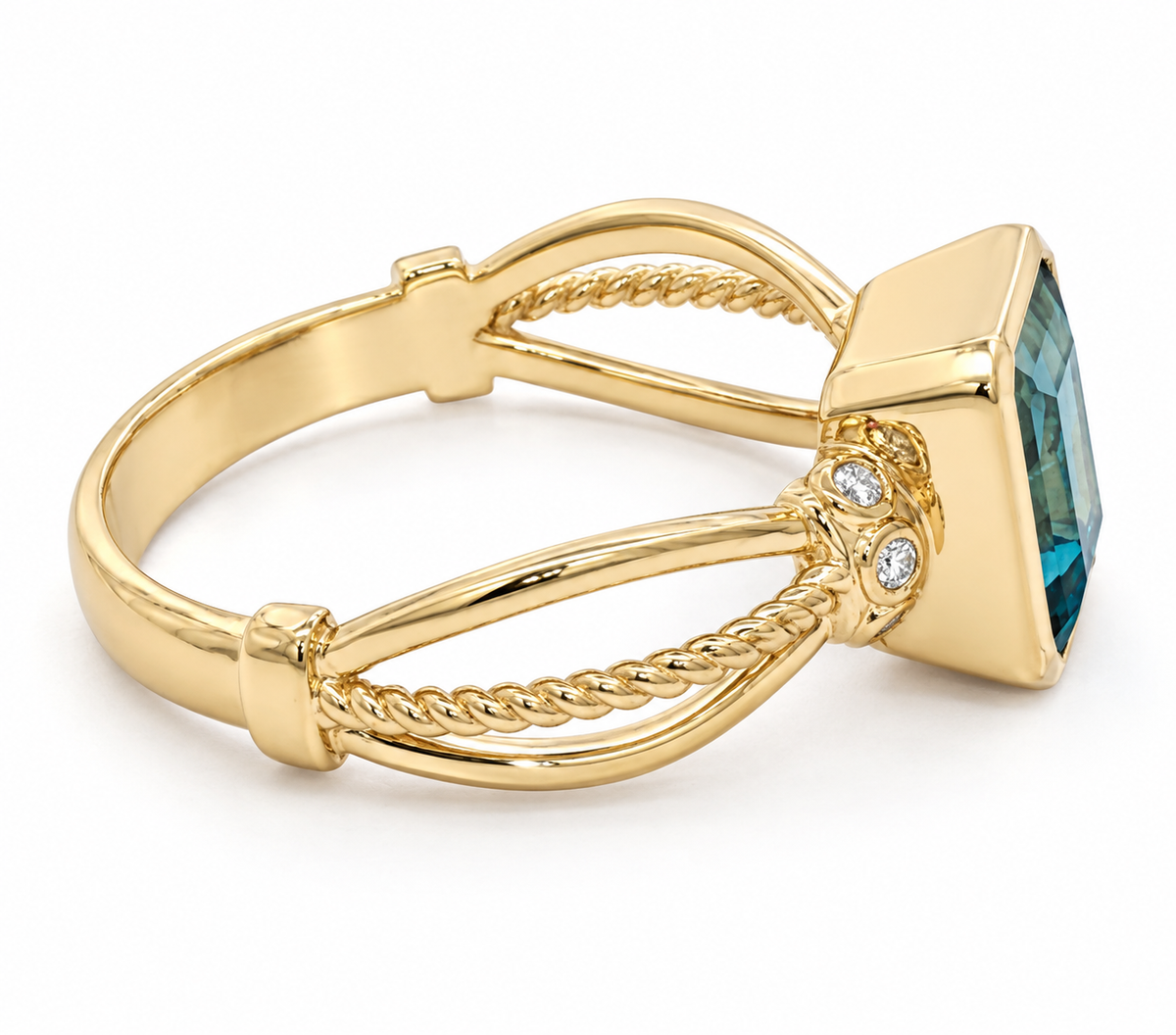 A yellow gold ring with a square bezel-set blue gemstone and two small clear accent stones, shown on a clean white background.