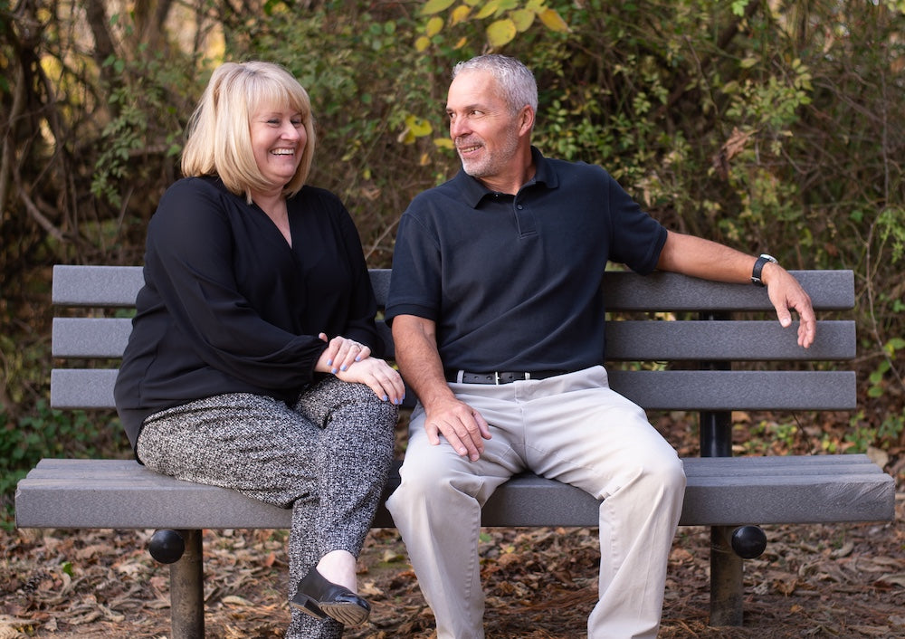 Two employees from Kent Island Jewelry sit on a bench at Terrapin Park