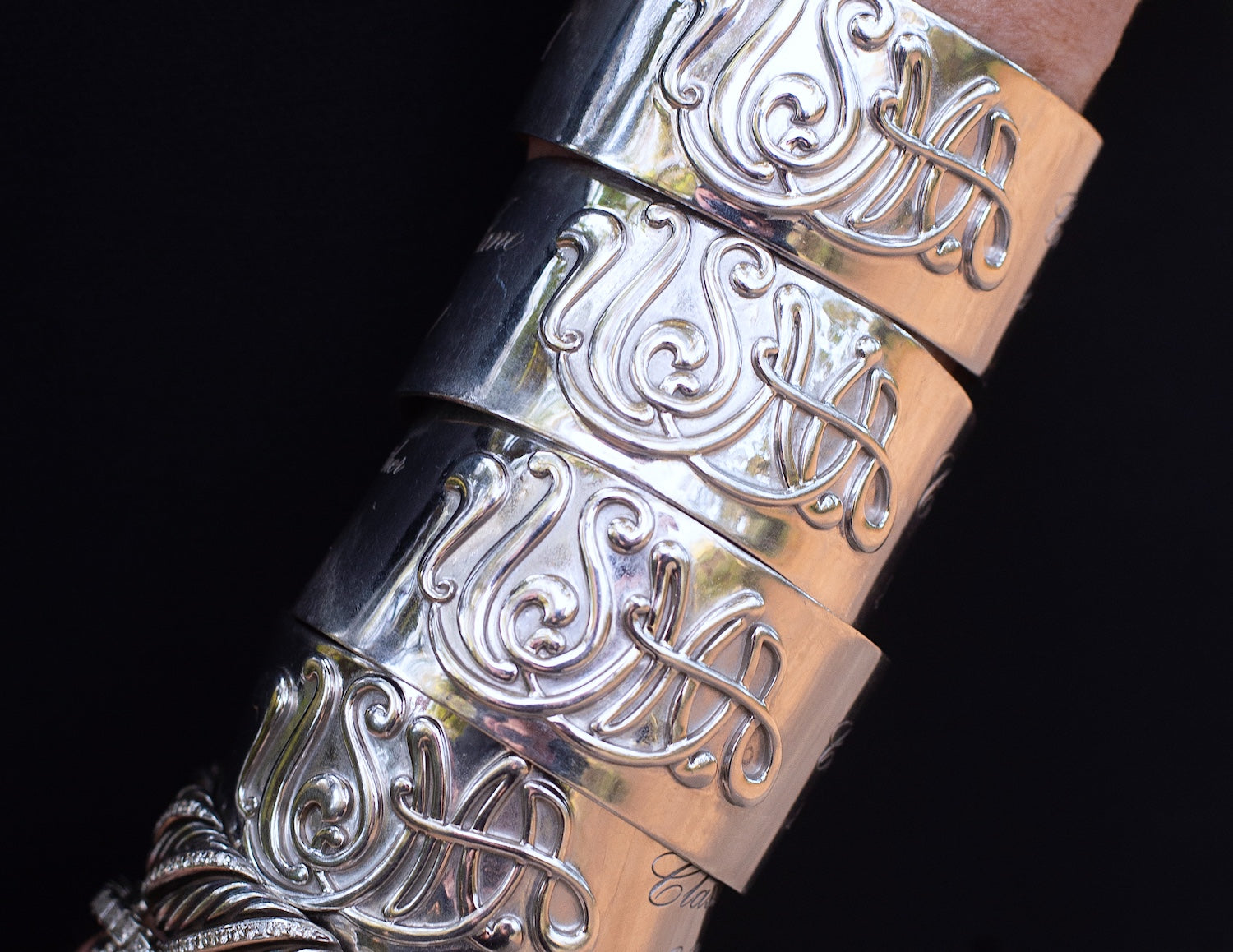 Silver arm bands engraved with USMA and USNA text