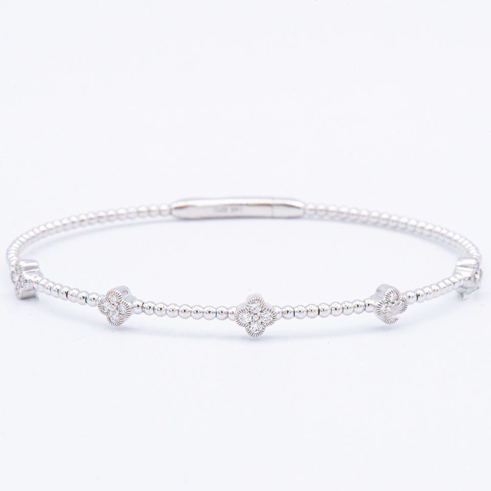 Epoque Jewelry 14k Diamond Clover Flex Bangle Bracelet with four diamond clover charms evenly spaced on the band.