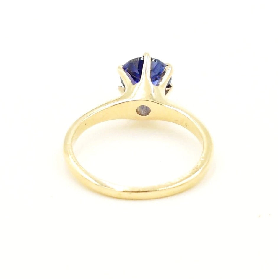 Estate 14k yellow gold blue sapphire solitaire ring by Kent Island Jewelry, shown from the back.