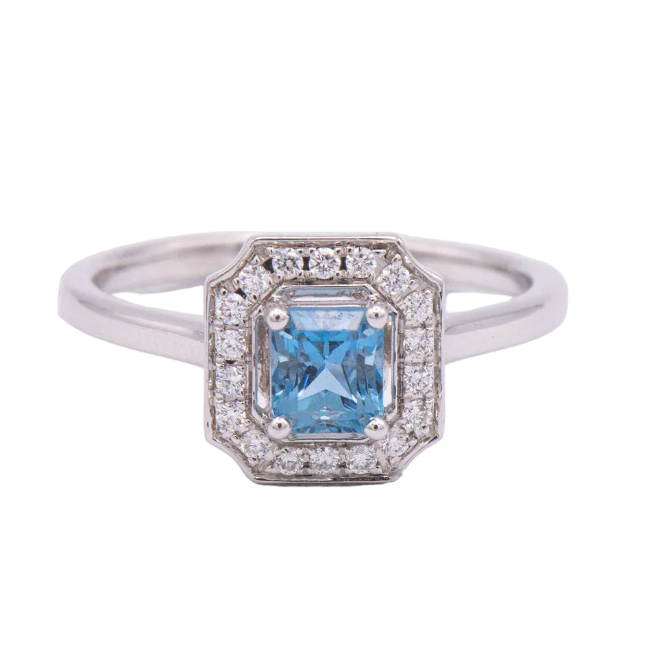 Kent Island Jewelry's 14K white gold ring features an emerald-cut aquamarine and diamond halo setting.