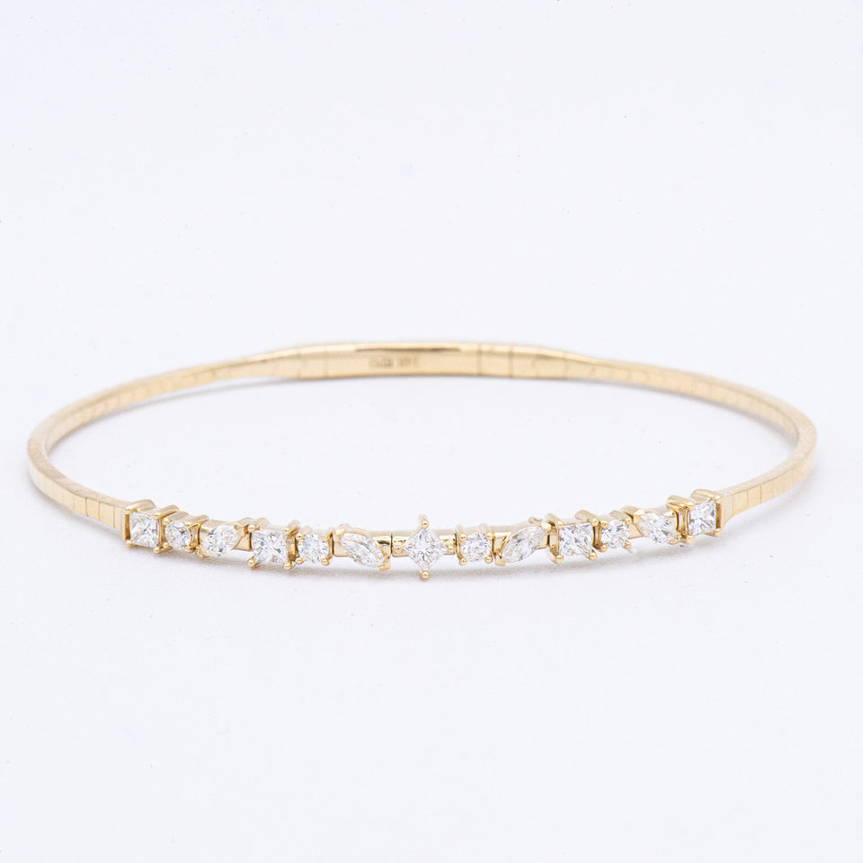 Epoque Jewelry's 14k Diamond Flex Bangle Bracelet—sleek gold with sparkling diamonds set in a flexible design.