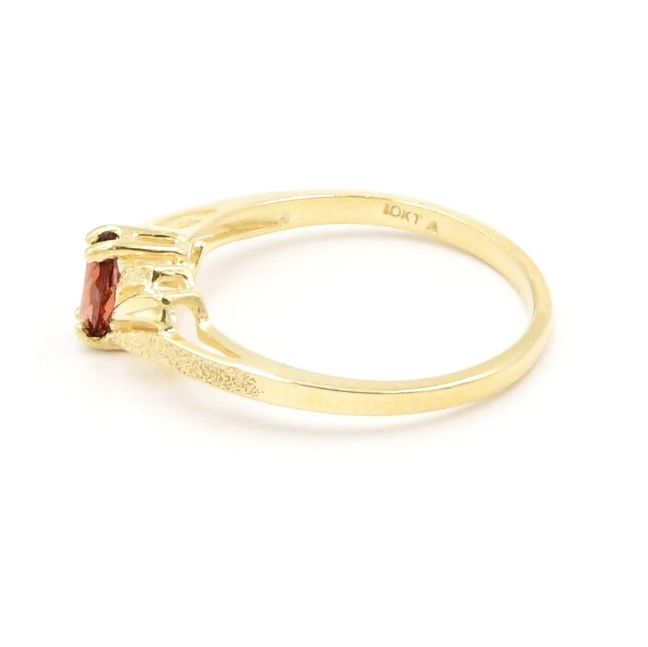 Kent Island Jewelry Estate 10k yellow gold open work ring with a prong-set garnet, marked 10KT inside the band.