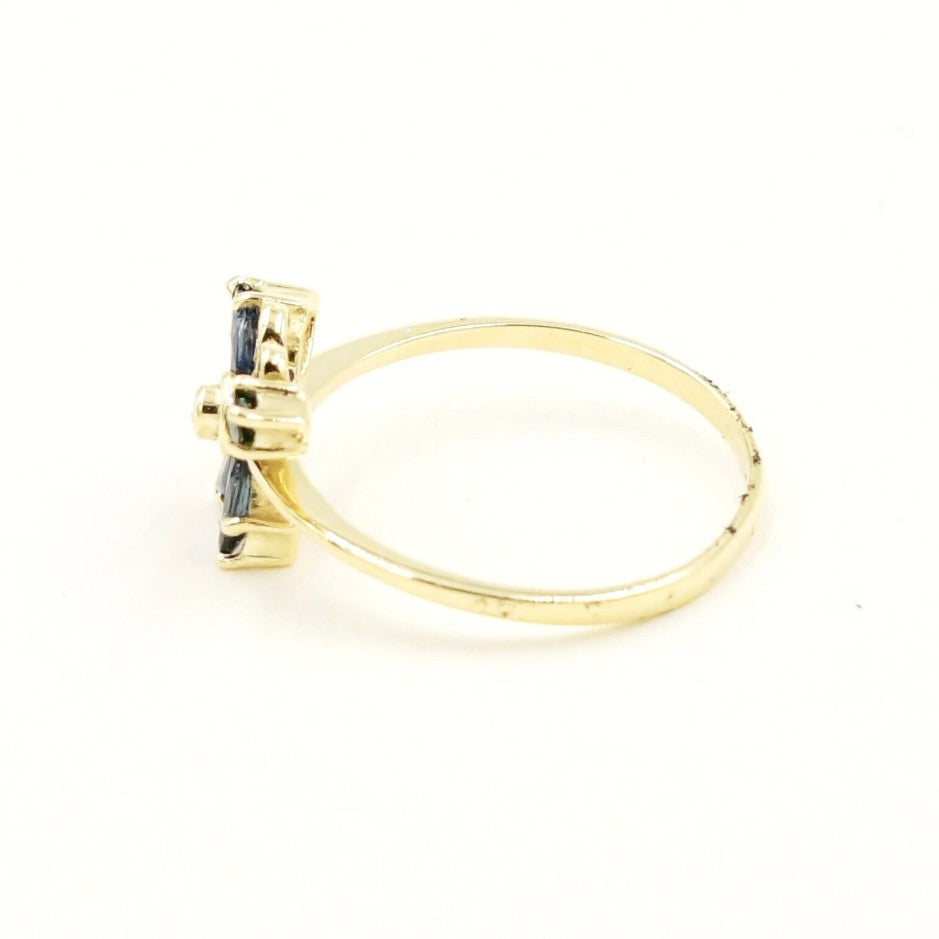 Estate 14k yellow gold blue spinel butterfly ring by Kent Island Jewelry, shown from the side on white background.