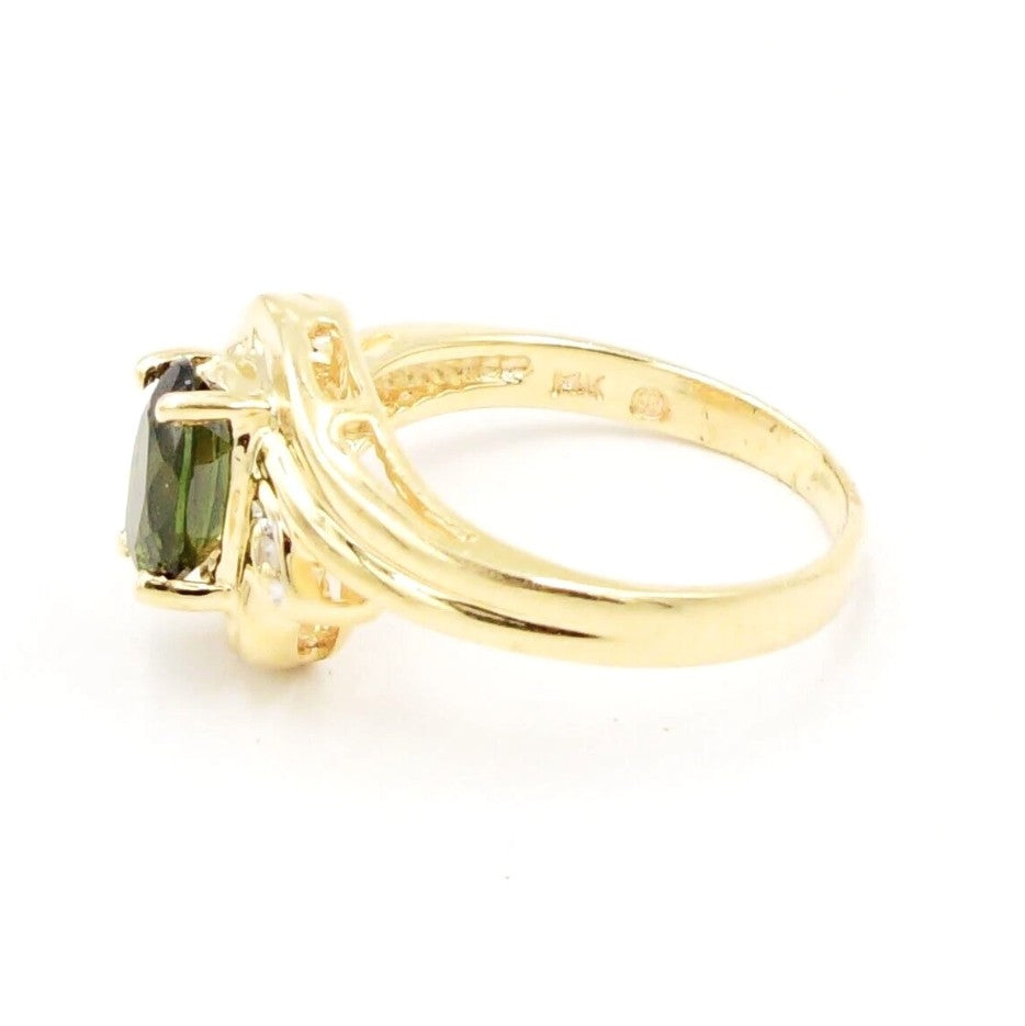 Kent Island Jewelry's Estate 14k YG ring features a .01ctw diamond and emerald in an elegant, raised band setting.