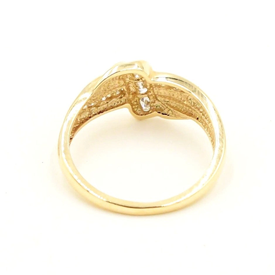 Kent Island Jewelry Estate 14k YG .16tcw diamond X crossover band ring on white background.